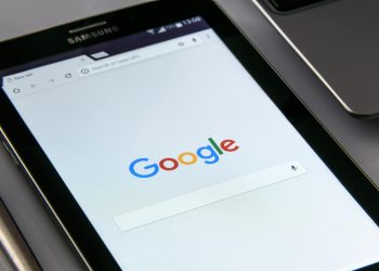 Close-up of a tablet displaying Google's search screen, emphasizing technology and internet browsing.