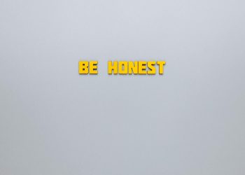 Simple yellow text 'Be Honest' on a neutral background, emphasizing clarity and inspiration.