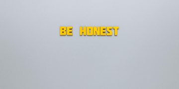 Simple yellow text 'Be Honest' on a neutral background, emphasizing clarity and inspiration.