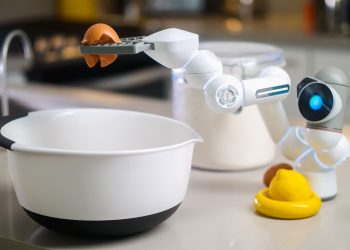 A robotic helper cracks an egg into a bowl in a contemporary kitchen setting, showcasing automation in cooking.