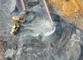 A top-down view showcasing mining operations with excavators and conveyor belts.