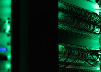 a rack of electronic equipment in a dark room