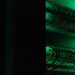 a rack of electronic equipment in a dark room