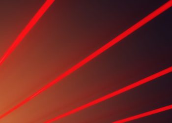 Abstract image with vibrant red laser beams on a dark gradient backdrop, illustrating futuristic design.