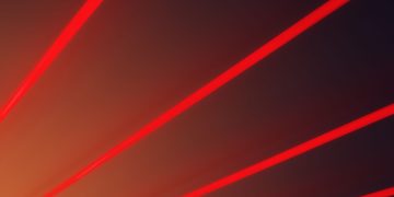 Abstract image with vibrant red laser beams on a dark gradient backdrop, illustrating futuristic design.