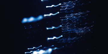 Dynamic abstract photograph of blue light patterns with a dark backdrop, creating a sense of motion and mystery.