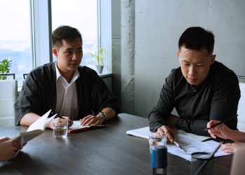 Group of professionals discussing business strategies in a modern office setting.