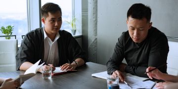 Group of professionals discussing business strategies in a modern office setting.