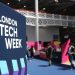 Vibrant indoor scene at London Tech Week with attendees and colorful displays.