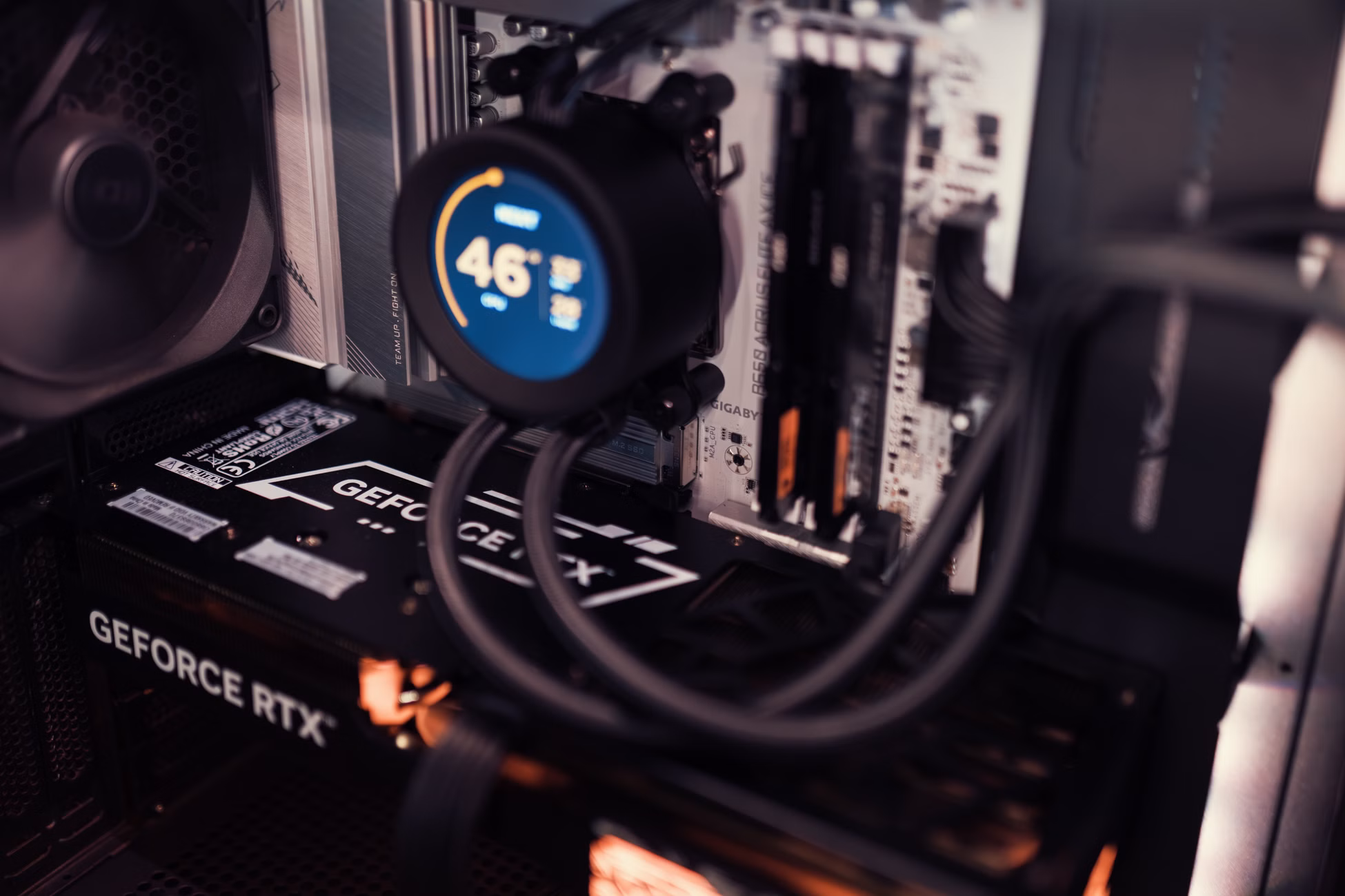 Close-up of a gaming PC interior featuring a GeForce RTX graphics card and cooling system.