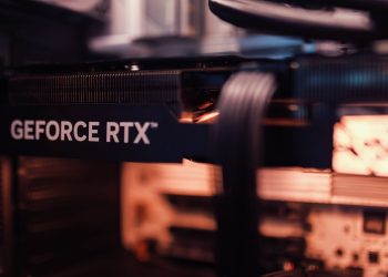 Detailed view of a GeForce RTX graphics card installed in a computer setup, highlighting modern technology.