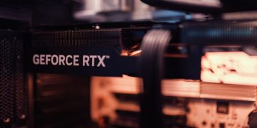 Detailed view of a GeForce RTX graphics card installed in a computer setup, highlighting modern technology.