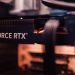 Detailed view of a GeForce RTX graphics card installed in a computer setup, highlighting modern technology.