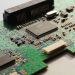 Detailed close-up photo of a circuit board highlighting microchip components and electronic circuits.