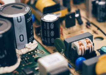 Detailed close-up of capacitors and components on a circuit board, showcasing electronic technology.