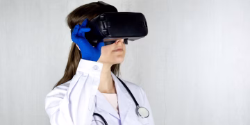 Doctor in a lab coat exploring virtual reality technology with goggles.
