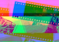 Vibrant display of overlapping photographic film rolls in abstract colors.