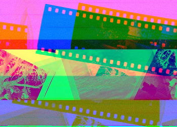Vibrant display of overlapping photographic film rolls in abstract colors.