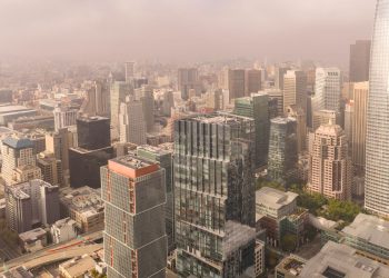 Stunning aerial view of San Francisco's modern skyline showcasing prominent skyscrapers on a foggy day.