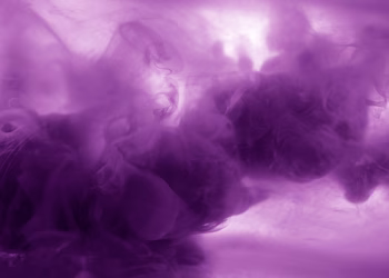 Vibrant purple smoke texture with flowing abstract patterns, perfect for creative backgrounds.