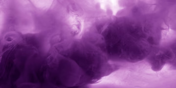 Vibrant purple smoke texture with flowing abstract patterns, perfect for creative backgrounds.