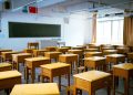 a classroom filled with lots of wooden desks