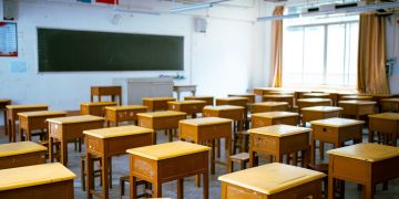 a classroom filled with lots of wooden desks
