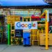 google logo beside building near painted walls at daytime