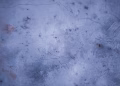 Textured frozen lake surface captured from above during winter in Weaver, Minnesota.