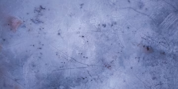 Textured frozen lake surface captured from above during winter in Weaver, Minnesota.