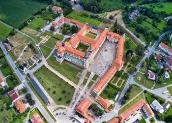 A stunning aerial view of Velehrad Monastery surrounded by lush greenery and rooftops in Czech Republic.