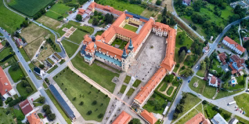 A stunning aerial view of Velehrad Monastery surrounded by lush greenery and rooftops in Czech Republic.