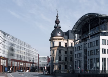 Explore Hamburg's cityscape with a blend of historic and modern architecture under a bright sky.
