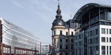 Explore Hamburg's cityscape with a blend of historic and modern architecture under a bright sky.