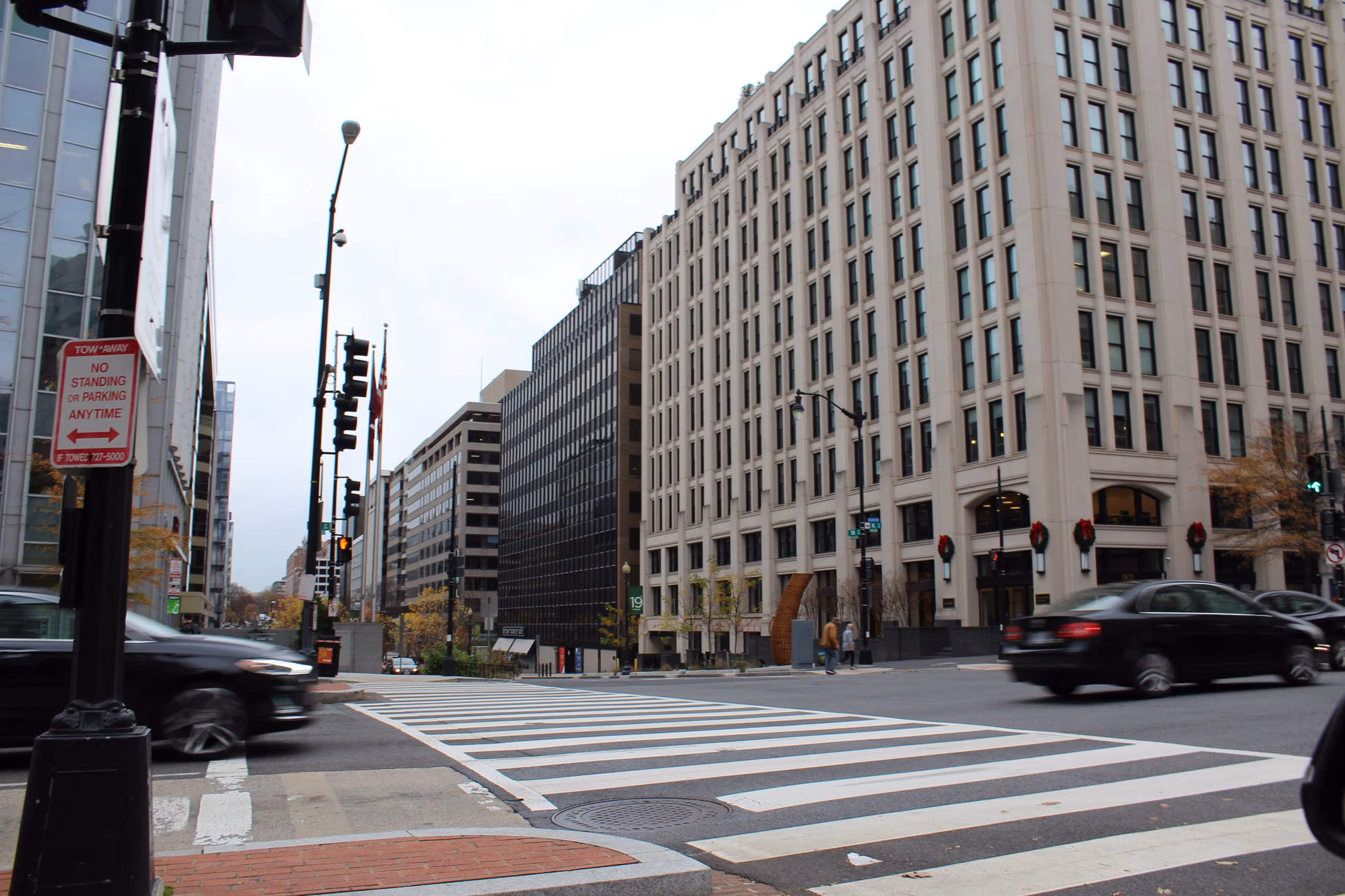 Dynamic city street scene in Washington, DC showcasing modern architecture and bustling traffic.