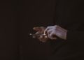silhouette photo of person holding smartphone