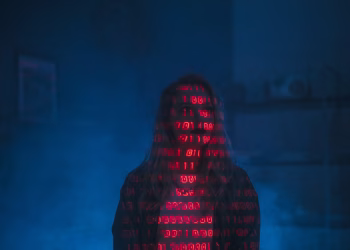 A mysterious silhouette with red binary code projected over the face, set against a dark, moody background.