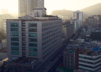 Aerial shot of a densely built urban area with modern architecture during sunset.