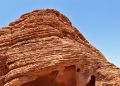 Stunning red rock formations against a clear blue sky, showcasing natural texture patterns.