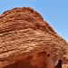 Stunning red rock formations against a clear blue sky, showcasing natural texture patterns.