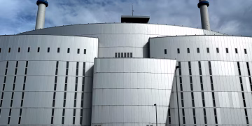 Front view of a modern industrial building with chimneys in Rotterdam.