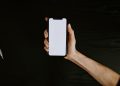 person holding white iphone 5 c