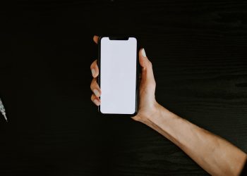 person holding white iphone 5 c