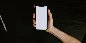 person holding white iphone 5 c