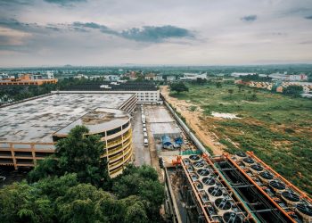 Industrial complex with adjacent greenery, highlighting cityscape and infrastructure.