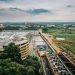 Industrial complex with adjacent greenery, highlighting cityscape and infrastructure.