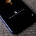 Mobile phone with no face detected message on lock screen on a textured fabric surface.