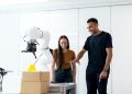 Two engineers collaborating on testing a futuristic robotic prototype in a modern indoor lab.