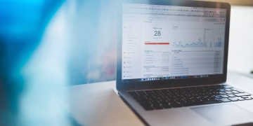 Laptop displaying Google Analytics in a modern workspace, highlighting digital analytics and technology.