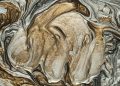 Elegant marbled art pattern with swirling golden and silver hues. Perfect for abstract art lovers.